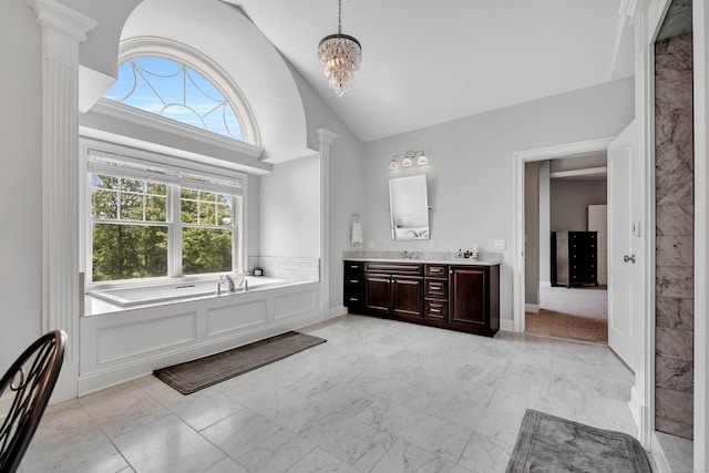 562 Upper Grassy Hill Rd, Woodbury, CT 06798 - full bathroom featuring marble look tiles, double vanity, a garden tub, decorative columns, and a chandelier