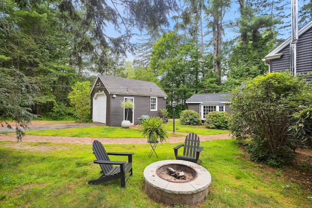 291 Hopmeadow St, Simsbury, CT 06089 - view of green lawn with a fire pit, an outdoor structure, and asphalt driveway