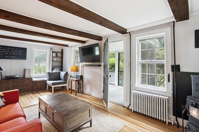291 Hopmeadow St, Simsbury, CT 06089 - living room featuring radiator, beamed ceiling, and wood-type flooring