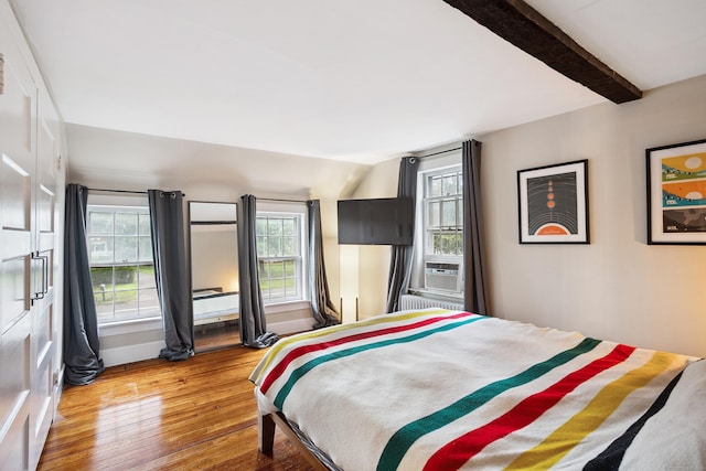 291 Hopmeadow St, Simsbury, CT 06089 - bedroom featuring hardwood / wood-style floors, multiple windows, cooling unit, and radiator