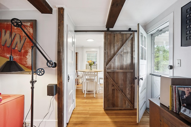 291 Hopmeadow St, Simsbury, CT 06089 - foyer with beam ceiling, a barn door, and light wood-style flooring