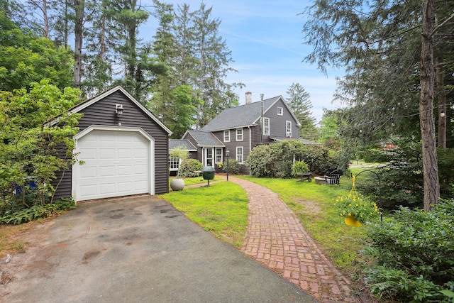 291 Hopmeadow St, Simsbury, CT 06089 - view of front of home with an outdoor structure, driveway, a chimney, and a front lawn