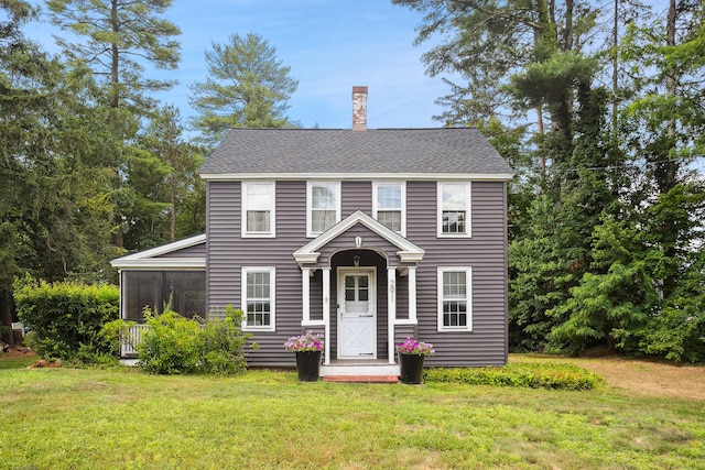 291 Hopmeadow St, Simsbury, CT 06089 - colonial-style house featuring a chimney, a front yard, a sunroom, and a shingled roof