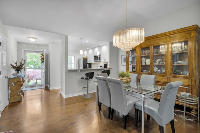 26 Legend Hill Rd Unit 26, Madison, CT 06443 - dining area featuring baseboards, a chandelier, and dark wood finished floors