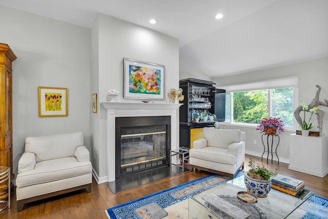 26 Legend Hill Rd Unit 26, Madison, CT 06443 - living area with a glass covered fireplace, lofted ceiling, wood finished floors, baseboards, and recessed lighting