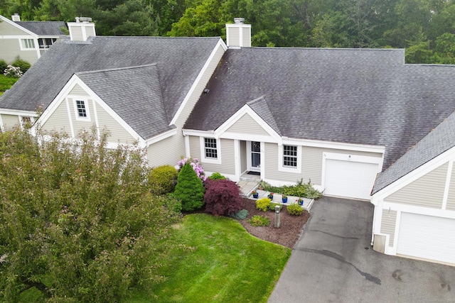 26 Legend Hill Rd Unit 26, Madison, CT 06443 - view of front of home featuring a chimney, asphalt driveway, roof with shingles, and an attached garage