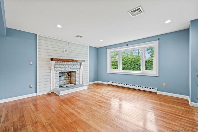99 Redwood Dr, Bristol, CT 06010 - unfurnished living room featuring a baseboard heating unit, wood finished floors, a brick fireplace, baseboards, and recessed lighting