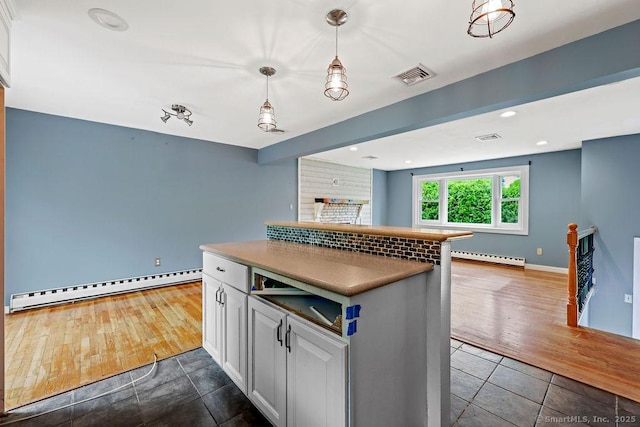 99 Redwood Dr, Bristol, CT 06010 - kitchen featuring a baseboard radiator, open floor plan, dark tile patterned floors, baseboards, and white cabinets