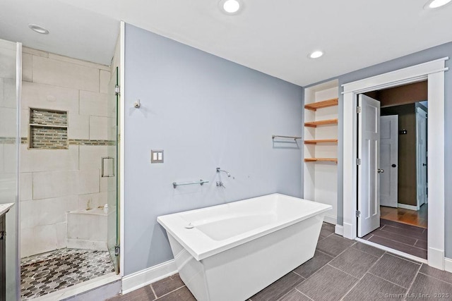 99 Redwood Dr, Bristol, CT 06010 - bathroom with a soaking tub, a shower stall, recessed lighting, and baseboards
