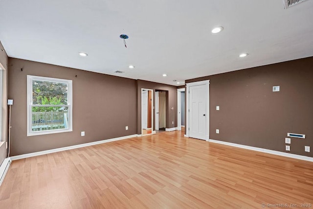99 Redwood Dr, Bristol, CT 06010 - unfurnished room with light wood-style flooring, baseboards, recessed lighting, and a baseboard heating unit