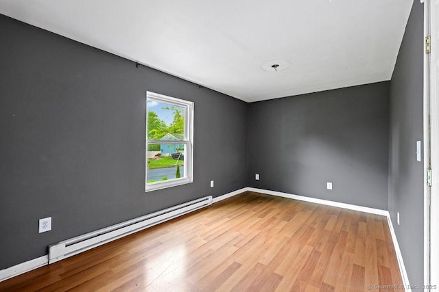99 Redwood Dr, Bristol, CT 06010 - empty room with wood finished floors, a baseboard heating unit, and baseboards