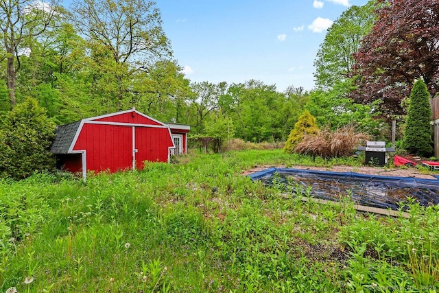 99 Redwood Dr, Bristol, CT 06010 - view of yard with an outdoor structure and a forest view