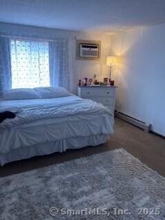 26 Guiel Pl Apt 5, Meriden, CT 06450 - bedroom with a baseboard radiator, a wall mounted AC, and wood finished floors