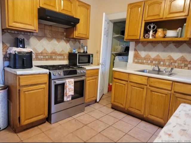 45 Washington Pl, Bridgeport, CT 06604 - kitchen with stainless steel appliances, under cabinet range hood, a sink, light countertops, and tasteful backsplash