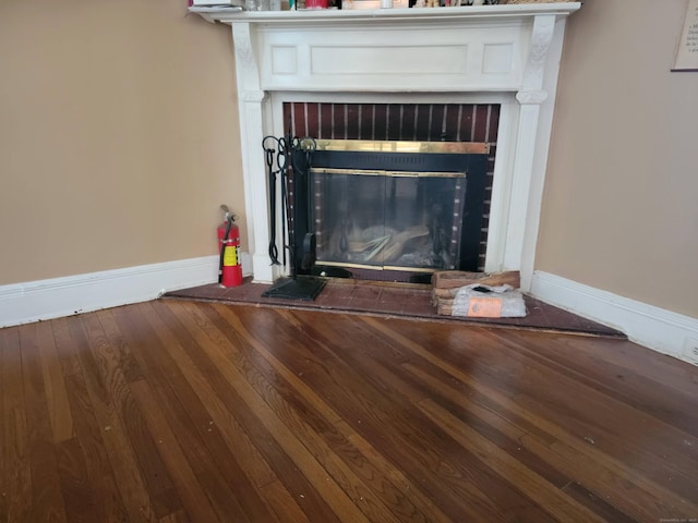 45 Washington Pl, Bridgeport, CT 06604 - detailed view of a fire extinguisher, a brick fireplace, wood finished floors, and baseboards