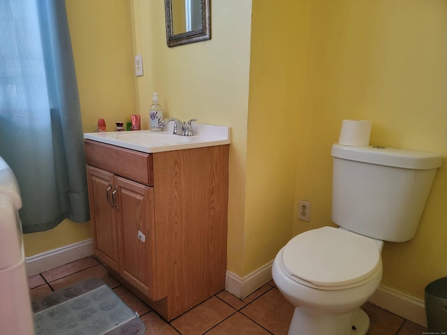 45 Washington Pl, Bridgeport, CT 06604 - half bathroom with tile patterned floors, vanity, toilet, and baseboards