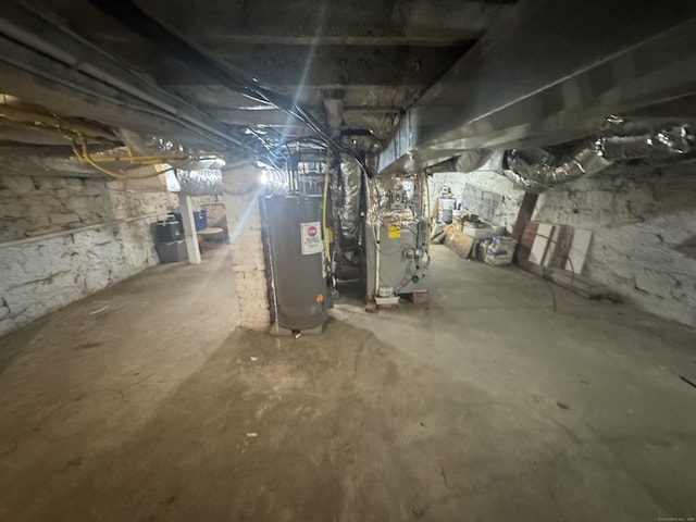 unfinished basement featuring water heater and heating unit