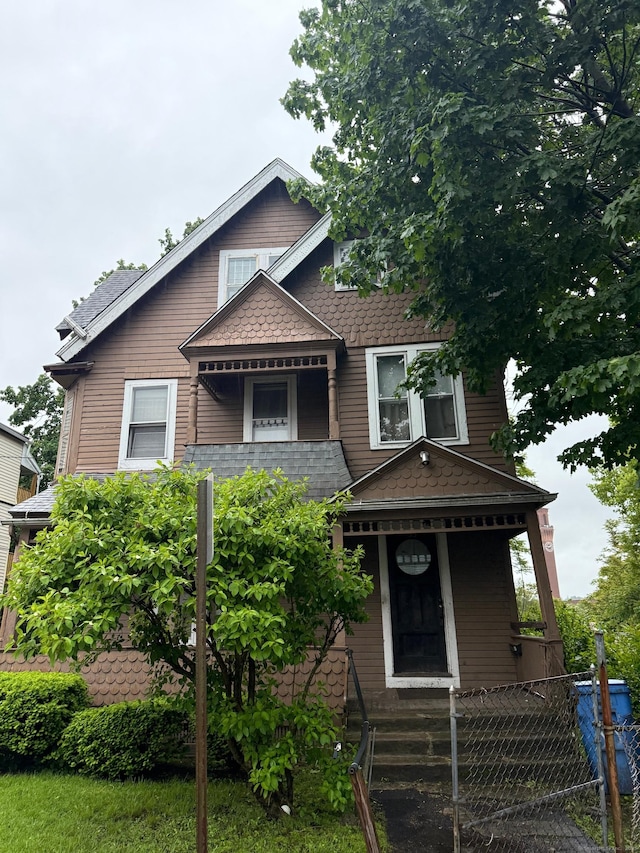 33 Mitchell Ave, Waterbury, CT 06710 - victorian home with a fenced front yard, covered porch, and roof with shingles