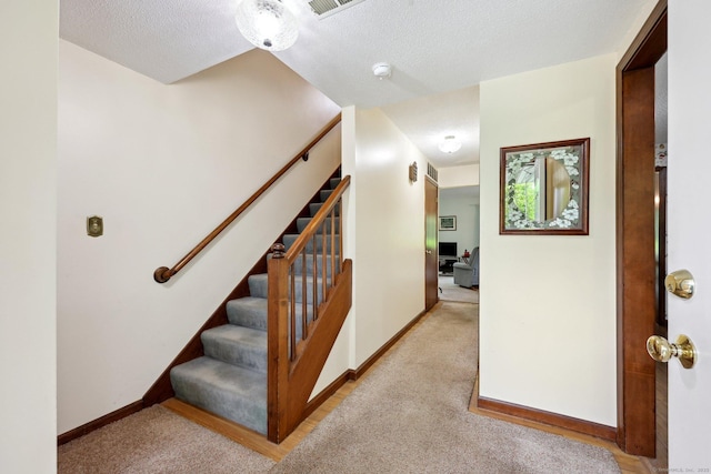1277 New Britain Ave Unit 1277, West Hartford, CT 06110 - staircase featuring baseboards, a textured ceiling, and carpet