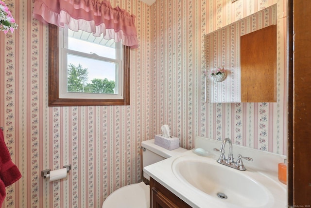 1277 New Britain Ave Unit 1277, West Hartford, CT 06110 - half bathroom featuring toilet, vanity, and wallpapered walls