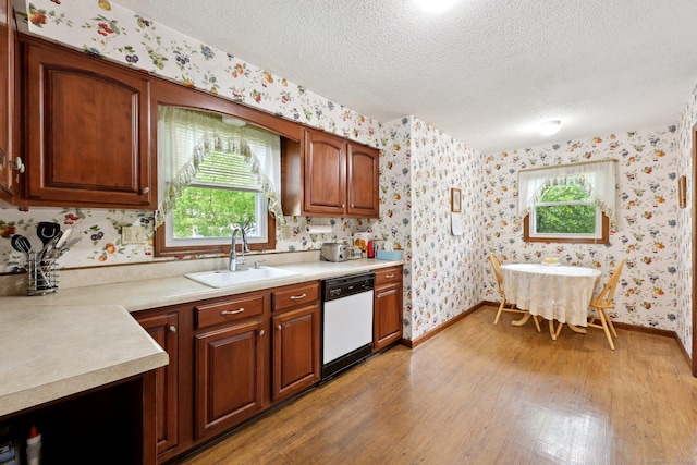 1277 New Britain Ave Unit 1277, West Hartford, CT 06110 - kitchen featuring dishwasher, a sink, wallpapered walls, light wood finished floors, and a textured ceiling