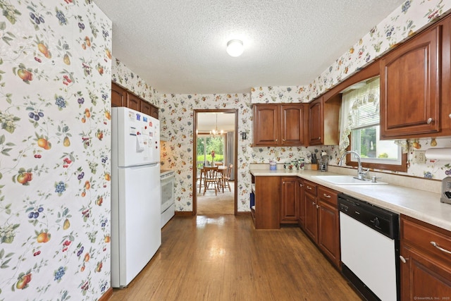 1277 New Britain Ave Unit 1277, West Hartford, CT 06110 - kitchen featuring white appliances, wallpapered walls, a sink, wood finished floors, and a textured ceiling