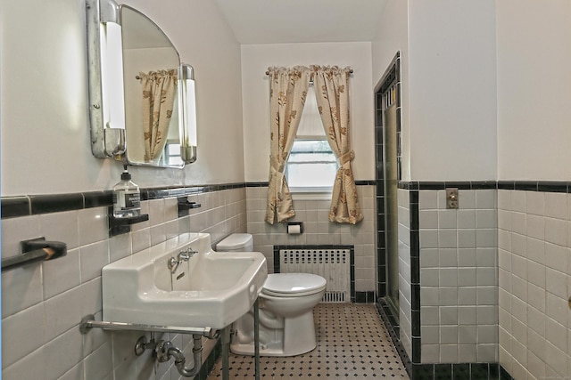 246 Ray Rd, New Haven, CT 06515 - bathroom with radiator, tile walls, and wainscoting