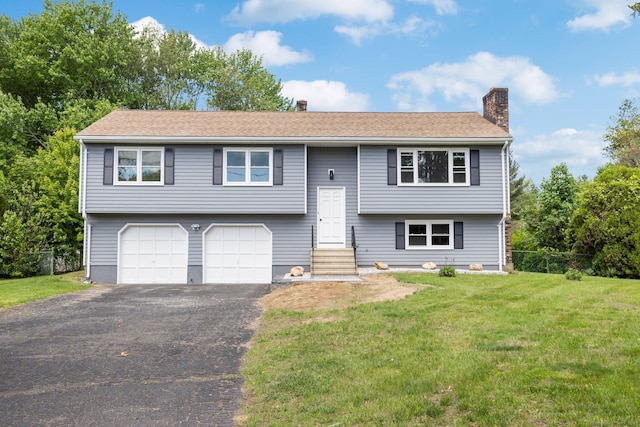 447 Palisado Ave, Windsor, CT 06095 - raised ranch featuring a chimney, asphalt driveway, a front lawn, and an attached garage