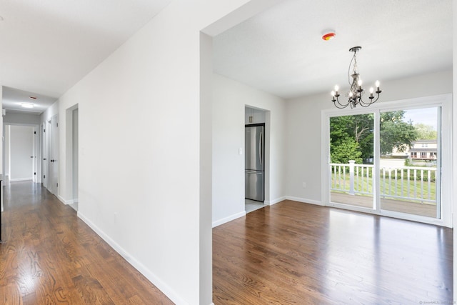 447 Palisado Ave, Windsor, CT 06095 - spare room featuring wood finished floors, a chandelier, and baseboards