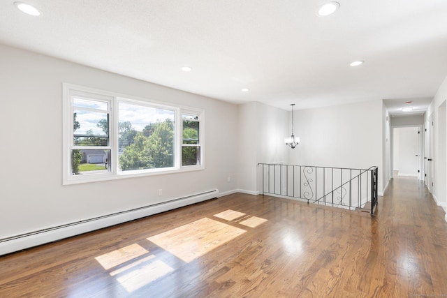 447 Palisado Ave, Windsor, CT 06095 - empty room with a baseboard radiator, recessed lighting, wood finished floors, a chandelier, and baseboards