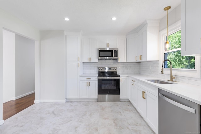 447 Palisado Ave, Windsor, CT 06095 - kitchen featuring stainless steel appliances, a sink, backsplash, light countertops, and white cabinetry