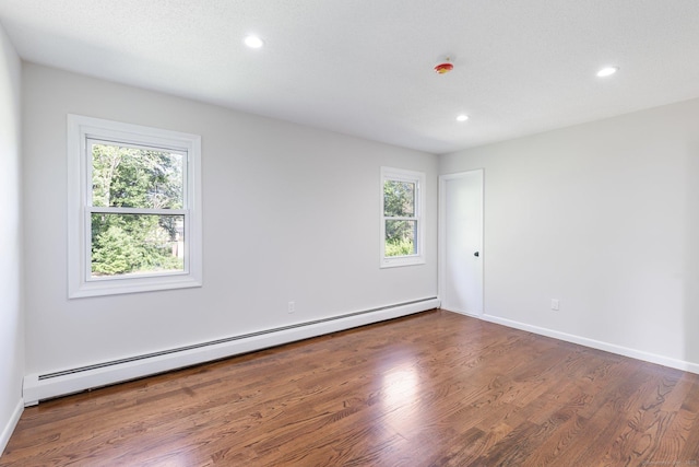 447 Palisado Ave, Windsor, CT 06095 - spare room featuring baseboard heating, recessed lighting, healthy amount of natural light, wood finished floors, and baseboards