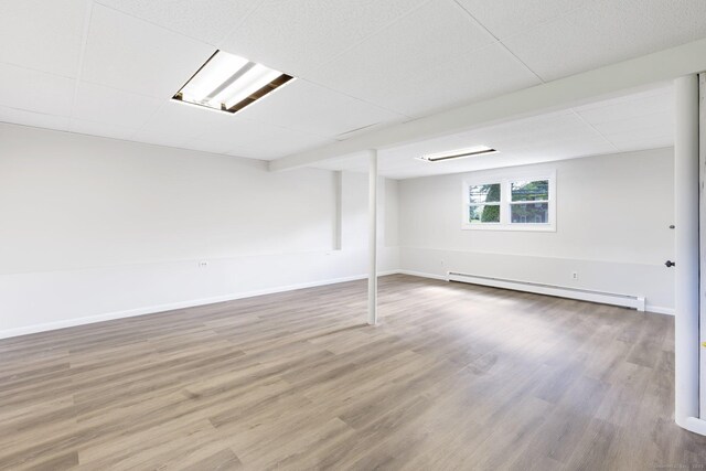 447 Palisado Ave, Windsor, CT 06095 - basement featuring a baseboard heating unit, wood finished floors, and baseboards