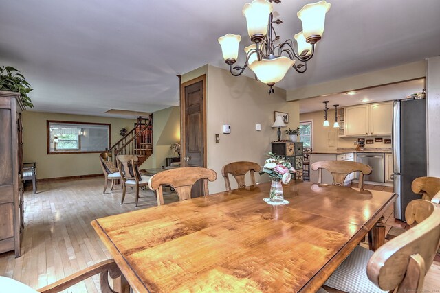 8 Whippoorwill Ln, Bethany, CT 06524 - dining area with stairs, healthy amount of natural light, light wood-style flooring, and a chandelier