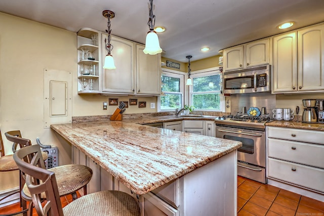 8 Whippoorwill Ln, Bethany, CT 06524 - kitchen featuring stainless steel appliances, a peninsula, electric panel, a breakfast bar, and hanging light fixtures