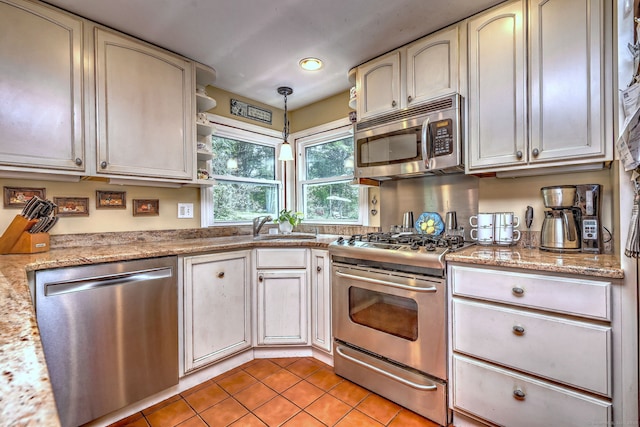 8 Whippoorwill Ln, Bethany, CT 06524 - kitchen with appliances with stainless steel finishes, light tile patterned flooring, pendant lighting, a sink, and light stone counters