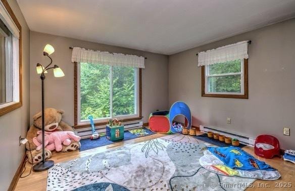 8 Whippoorwill Ln, Bethany, CT 06524 - rec room with baseboard heating, wood finished floors, and baseboards