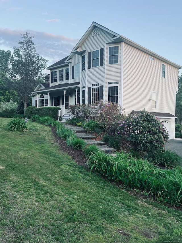 41 Mesa Dr, Bethany, CT 06524 - view of front facade with a porch, a front lawn, and a garage
