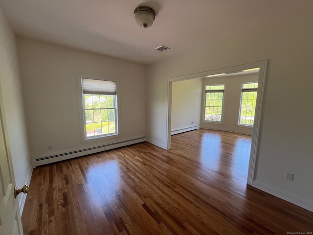 41 Mesa Dr, Bethany, CT 06524 - spare room featuring a baseboard radiator, healthy amount of natural light, and wood finished floors