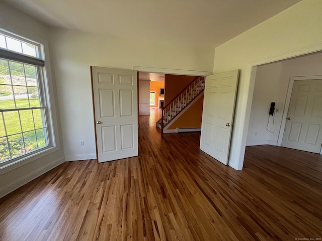41 Mesa Dr, Bethany, CT 06524 - unfurnished room with a baseboard heating unit, baseboards, wood finished floors, and stairs