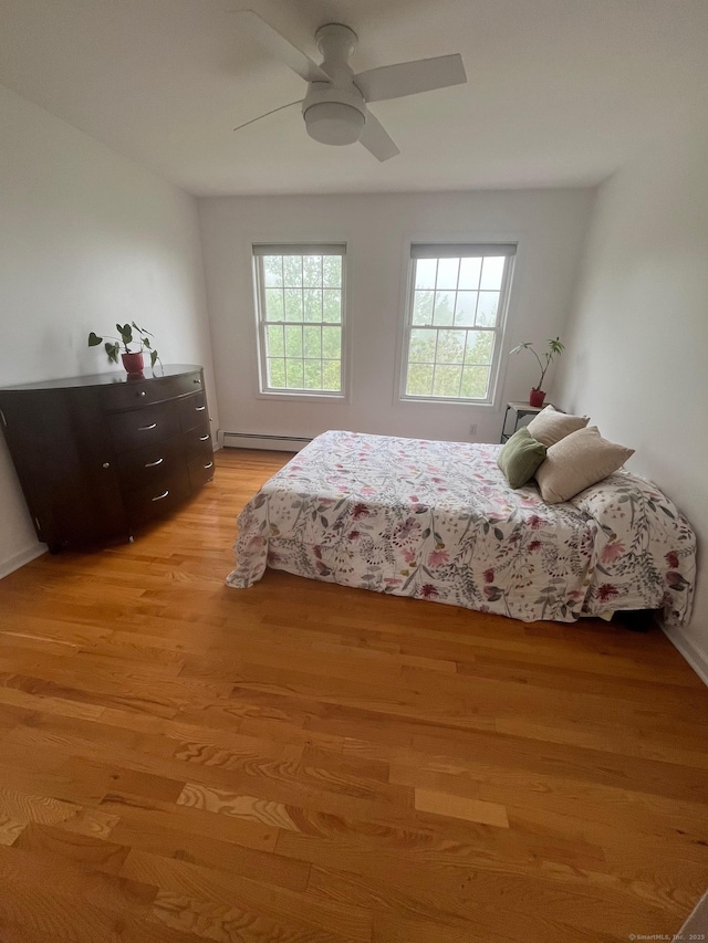 41 Mesa Dr, Bethany, CT 06524 - bedroom with a baseboard heating unit, light wood-style floors, and a ceiling fan