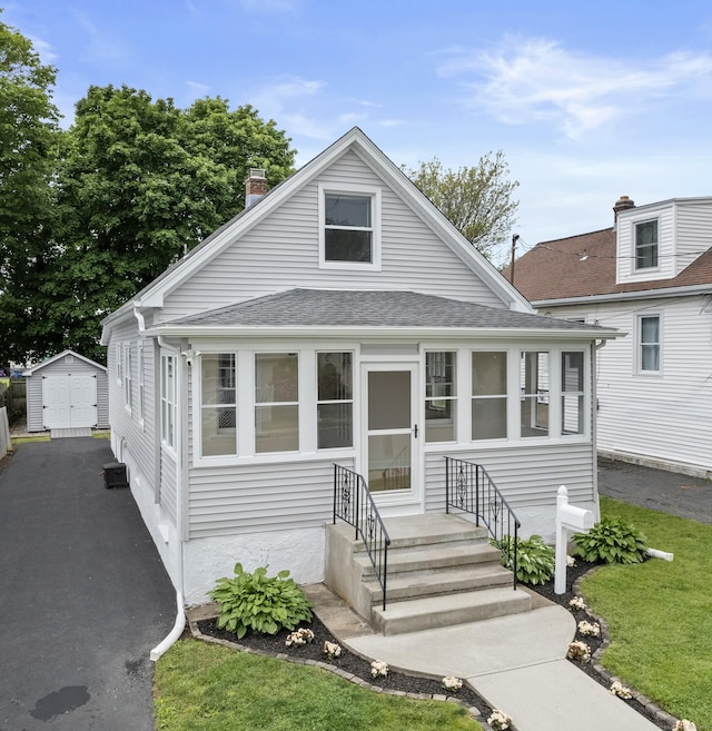 128 Grove Pl, West Haven, CT 06516 - view of front of property featuring roof with shingles and a chimney