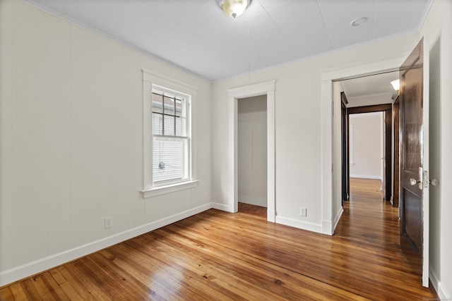 128 Grove Pl, West Haven, CT 06516 - unfurnished bedroom featuring wood-type flooring, ornamental molding, and baseboards