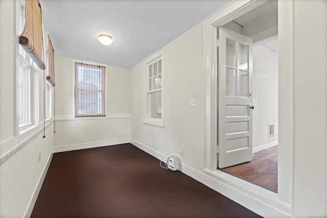 128 Grove Pl, West Haven, CT 06516 - spare room with dark wood-type flooring, baseboards, and plenty of natural light