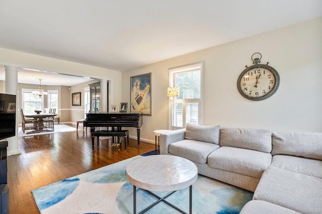 220 Bushy Hill Rd, Deep River, CT 06417 - living area with ornate columns, a chandelier, wood finished floors, and baseboards