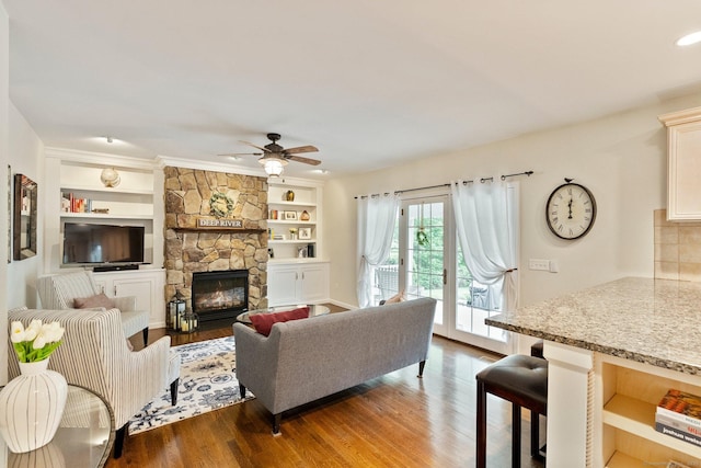 220 Bushy Hill Rd, Deep River, CT 06417 - living area with wood finished floors, a fireplace, ceiling fan, and built in shelves