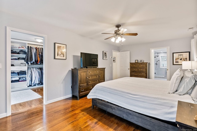 220 Bushy Hill Rd, Deep River, CT 06417 - bedroom featuring wood finished floors, a walk in closet, a closet, baseboards, and ensuite bath
