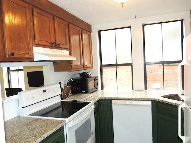 16 Essex St Unit 5F, Hartford, CT 06114 - kitchen with white appliances, ventilation hood, and brown cabinetry