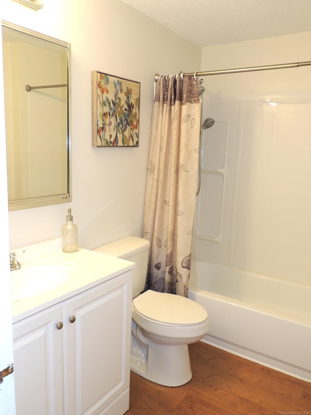16 Essex St Unit 5F, Hartford, CT 06114 - full bathroom with toilet, vanity, wood finished floors, shower / bathtub combination with curtain, and a textured ceiling