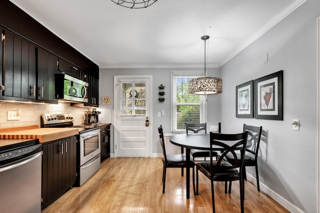 1 Stevens Rd, Middlebury, CT 06762 - kitchen featuring stainless steel appliances, light wood finished floors, decorative backsplash, baseboards, and crown molding